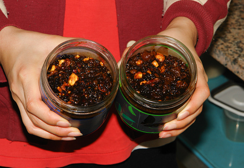 Woman holding glass jar with homemade jam