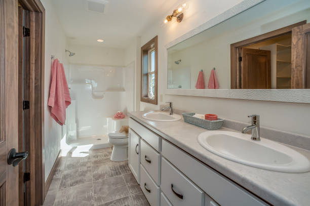 Large sized bathroom with double sinks, shower, and bathtub