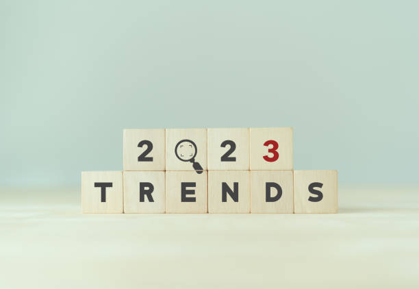 istock 2023 trend concept. Wooden cube with 2023, magnifying glass, TRENDS text. Beautiful grey background, copy space. Used for banner in trend concept in new year for monitoring new business opportunities. 1417192513