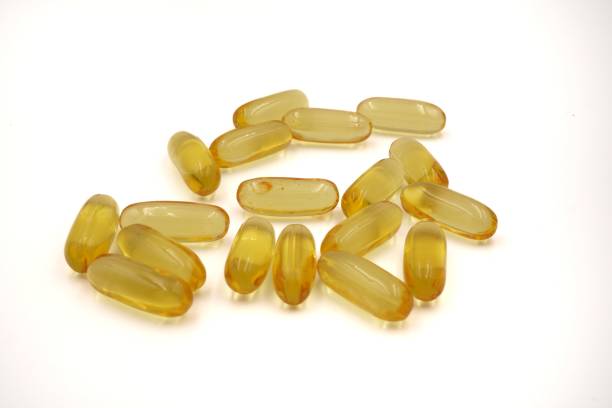 istock Medical: Golden Oval Fish Oil tablets in white background, close-up 1417193145