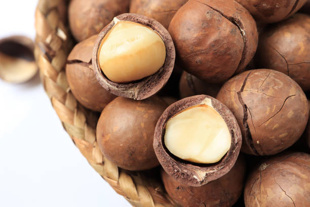 istock Organic Macadamia nuts in basket on white table. healthy food concept, empty space for text. 1417194168