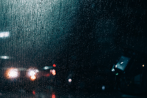 image of water droplets and bokeh on car window glass