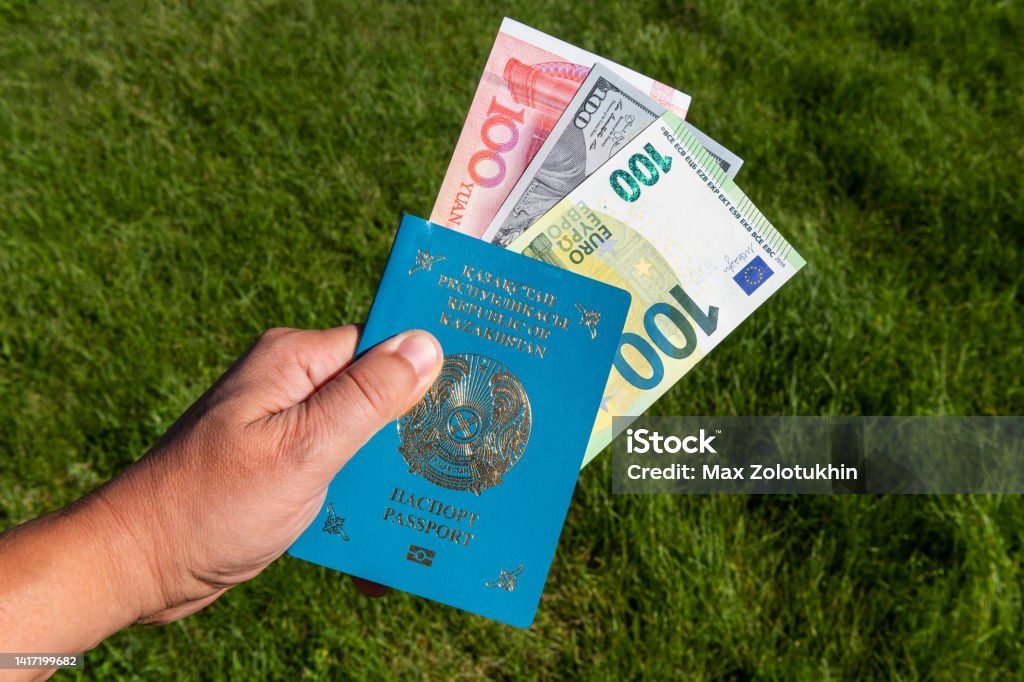 Kazakhstani passport and bills of 100 yuan, 100 dollars, 100 euros Passport Stock Photo