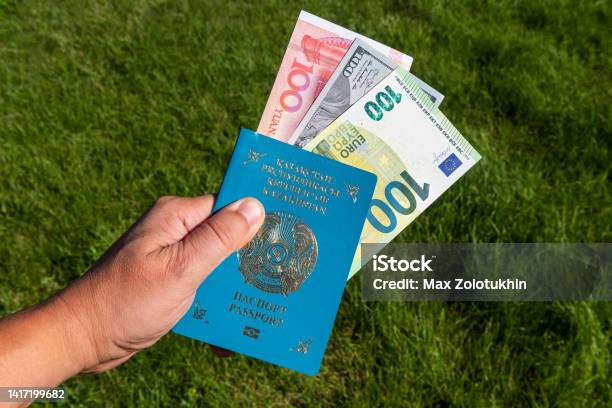 Kazakhstani Passport And Bills Of 100 Yuan 100 Dollars 100 Euros Stock Photo - Download Image Now
