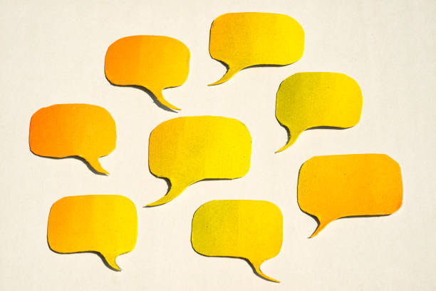 istock Yellow papercut speech bubbles on a white paper with copy space 1417205545