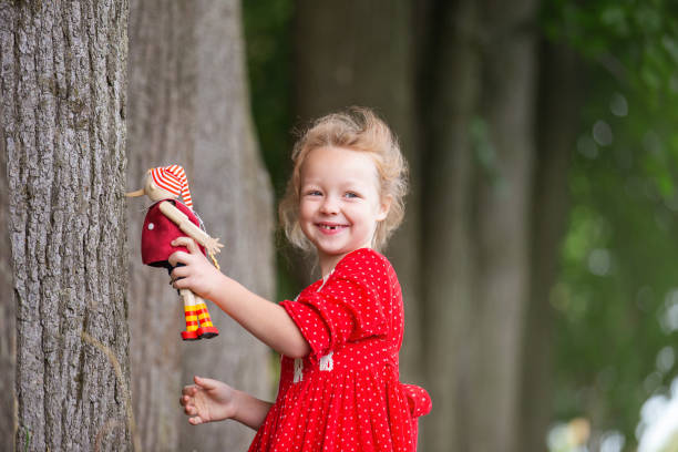 Little girl standing in burnt forest