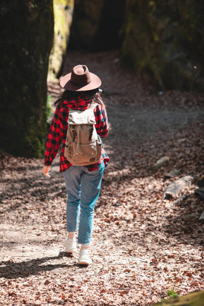 istock woman hiker with backpack walking by trail 1417209860