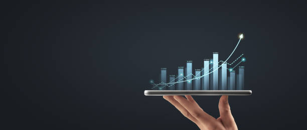 istock Hand holding smartphone device and touching screen. Stock exchange market concept 1417210184