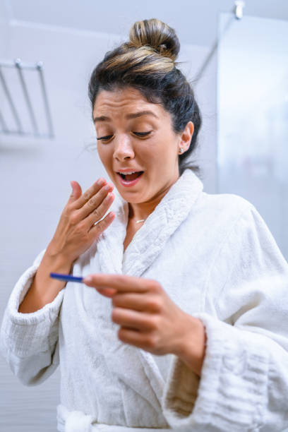 istock Happy woman holding pregnancy test 1417214352