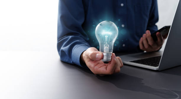 Business inspiration and solution image.Man holding lightbulb. stock photo