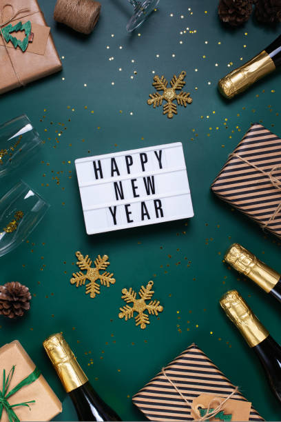 istock Happy New Year greeting card with champagne and gift boxes 1417221387