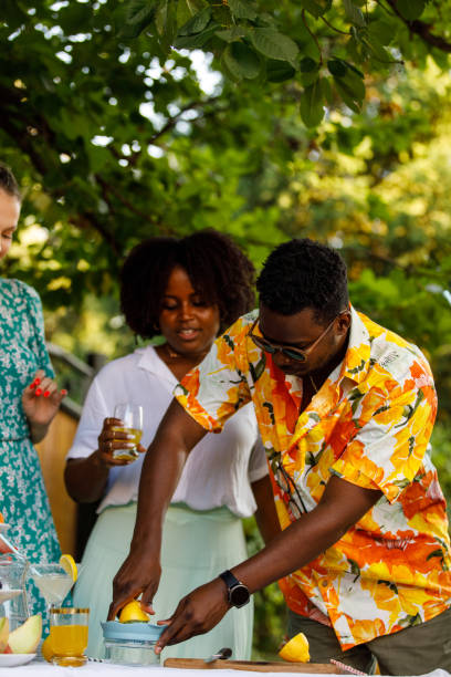istock Man making lemonade for friends during a summer garden party 1417226905