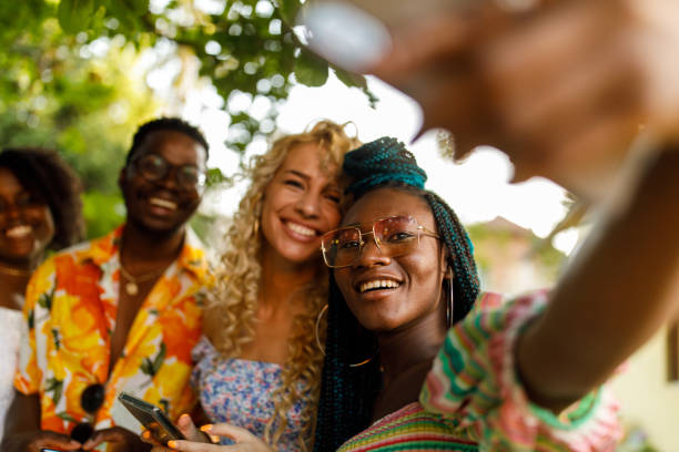 istock Four friends taking selfies during a fun garden party 1417227444