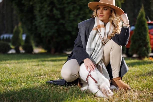 Fashionable young woman bonding with her new pet in city park