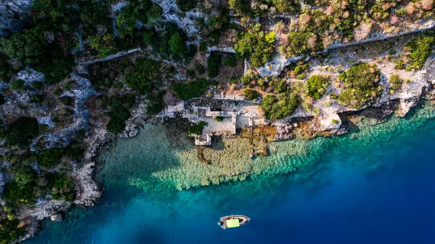 Photo of Simena - submerged ancient Lycian city Kekova island Ruins of ancient architecture, aerial view of a boat on a cruise in the sunken historical sunken city, place to explore the submarine, clean submarine,discovery spot for divers,aerial view of small boat