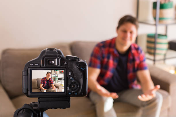 istock Vlogger recording social media video while sitting on the couch 1417234792