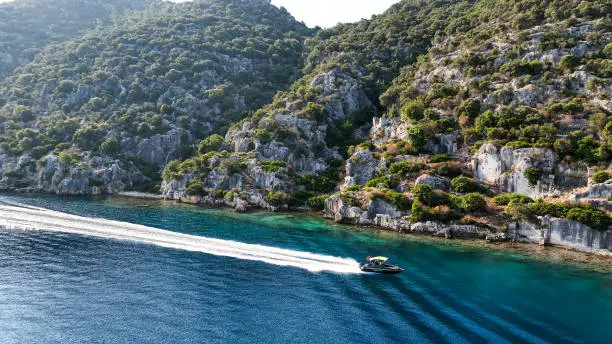 Photo of Simena - submerged ancient Lycian city Kekova island Ruins of ancient architecture, aerial view of a boat on a cruise in the sunken historical sunken city, place to explore the submarine, clean submarine,discovery spot for divers,aerial view of small boat