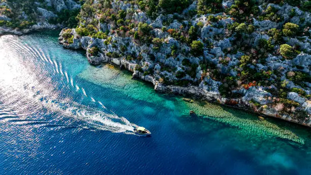 Photo of Simena - submerged ancient Lycian city Kekova island Ruins of ancient architecture, aerial view of a boat on a cruise in the sunken historical sunken city, place to explore the submarine, clean submarine,discovery spot for divers,aerial view of small boat