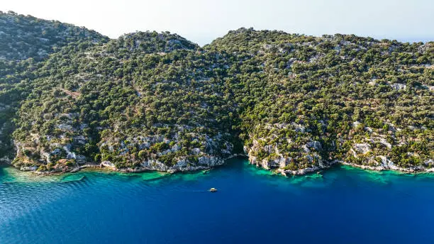 Photo of Simena - submerged ancient Lycian city Kekova island Ruins of ancient architecture, aerial view of a boat on a cruise in the sunken historical sunken city, place to explore the submarine, clean submarine,discovery spot for divers,aerial view of small boat