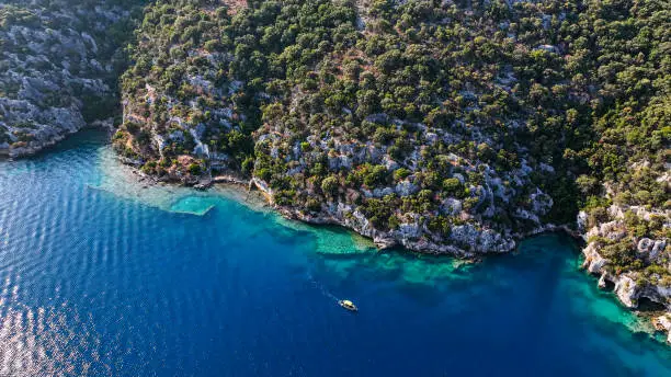 Photo of Simena - submerged ancient Lycian city Kekova island Ruins of ancient architecture, aerial view of a boat on a cruise in the sunken historical sunken city, place to explore the submarine, clean submarine,discovery spot for divers,aerial view of small boat