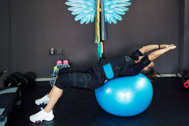 istock Athletic woman working out in an EMS suit 1417241119