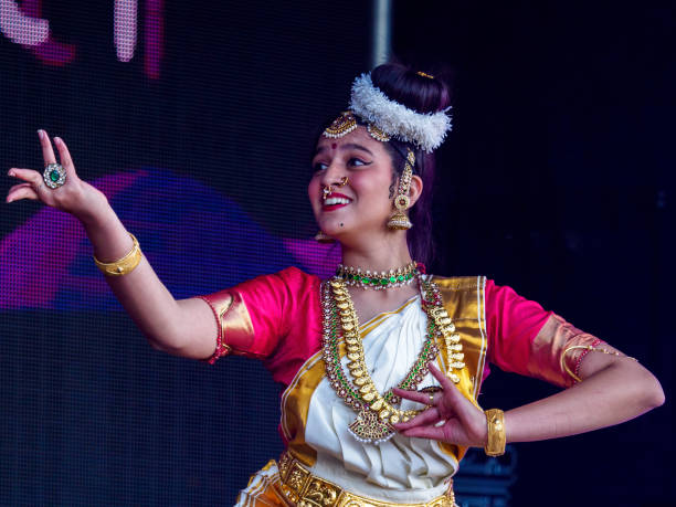Aberdeen, Scotland, UK - August 21, 2022: A South Asian dancer performing at the Mela One-World Day in Westburn Park, Aberdeen.  The Mela is a free multicultural event held annually in the city offering dance and music performers from other cultures who live in Scotland an opportunity to show off their cultural heritage.