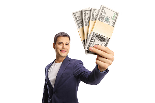 Professional young man showing money in front of camera isolated on white background