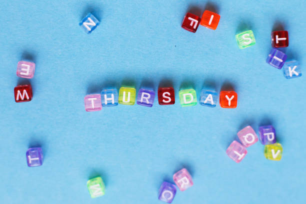 inscription thursday made by multicolor plastic cubes on a blue background