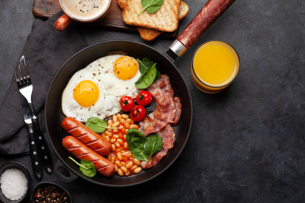 istock English breakfast with fried eggs, beans, bacon and sausages 1417255118