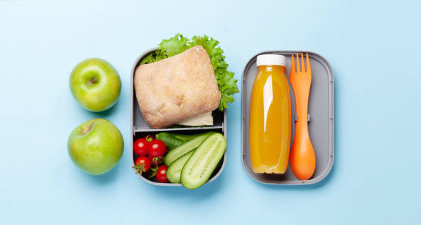 istock Lunch box with sandwich, vegetables and juice 1417256928