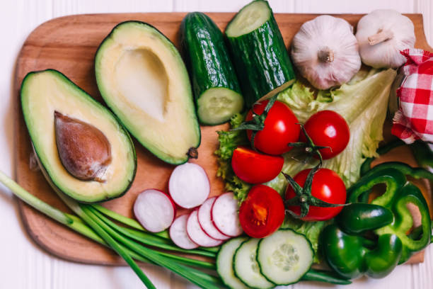 istock Ingredients for making salad. Vegetable salad, avocado, tomato, 1417257345