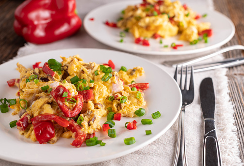 Homemade low carb breakfast plates with scrambled eggs, bell peppers, onions and chives.