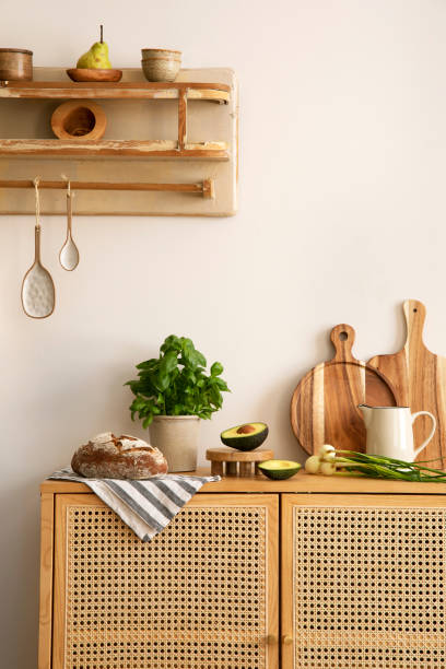 istock Creative composition of kitchen space with rattan commode and chair,  ladder, herbs, vegetables, food and kitchen accessories in modern home decor.  Template. 1417260436