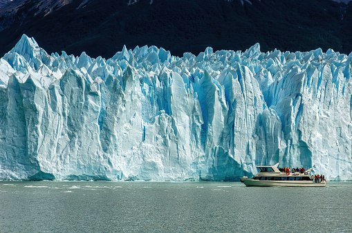 Cruise boat in front of Perito Moreno Glacier in Patagonia, Argentina, South America; guided boat tour on lake