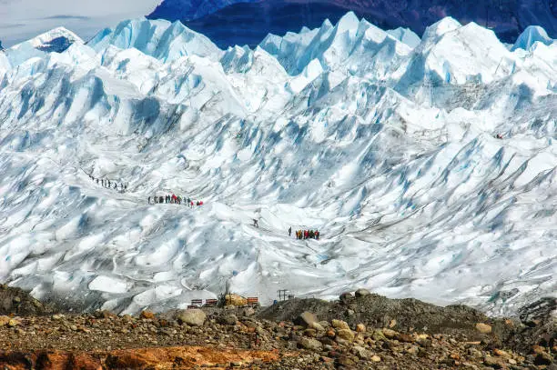 Tourists trekking on Perito Moreno Glacier in Los Glaciares National Park near El Calafate in Argentina, Patagonia, South America.