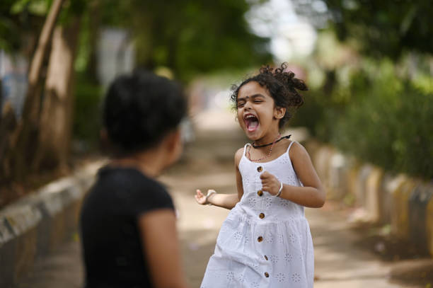istock Two cute girls playing in a park 1417271660