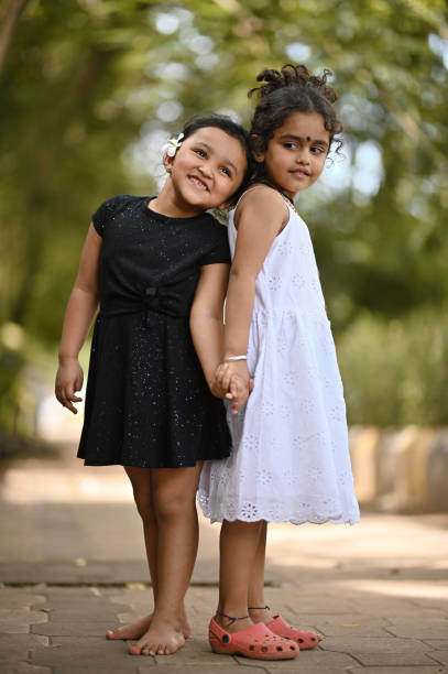 istock Two cute girls playing in a park 1417271671