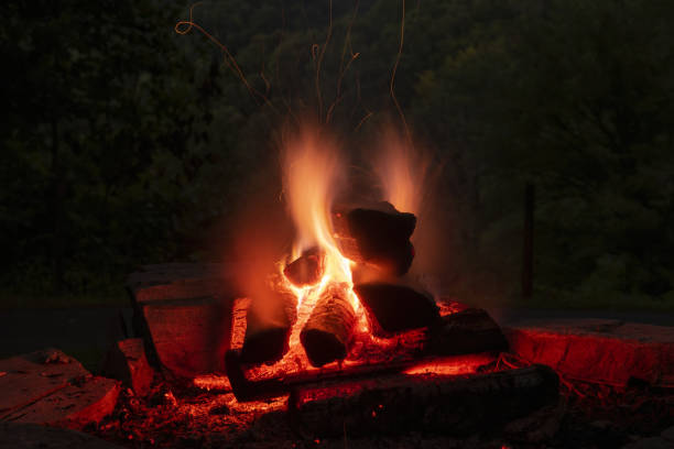 istock Long exposure of evening campfire with flames and curving ember making a light trails 1417275859
