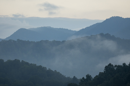 istock Layers of forested mountains with morning moisture rising after rain 1417275883