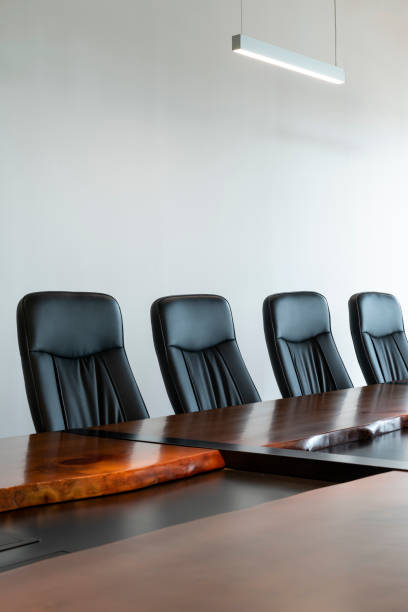 istock Meeting room with a big polished table and executive arm-chairs. 1417278060