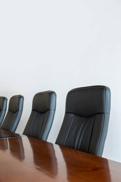 istock Meeting room with a big polished table and executive arm-chairs. 1417278064
