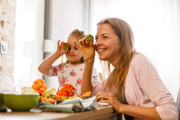istock Putting cut up kiwi fruit as their eyes when preparing healthy snacks 1417278154