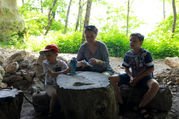 istock Mother with her sons relax in grotto on Una-Koz Ridge 1417278490