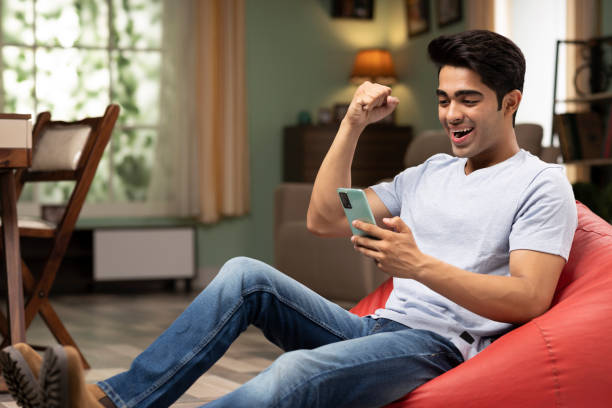 istock young man using phone at home, stock photo 1417280792
