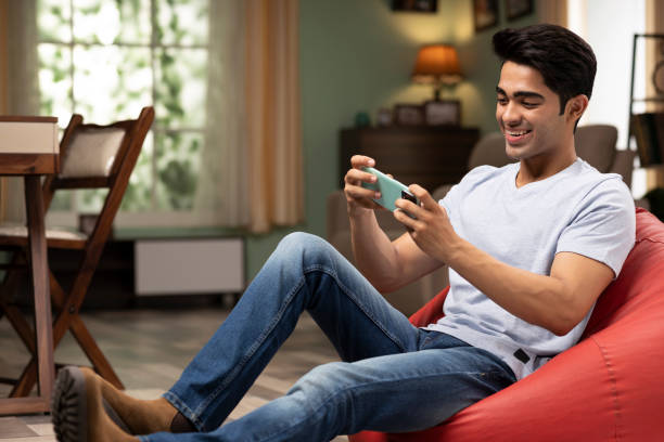 young man using phone at home, stock photo stock photo