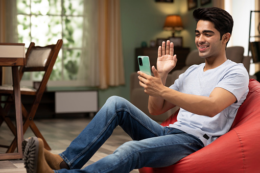 young man using phone at home