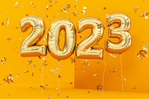 New Year Concept with Golden 2023 Balloons and Confetti on Yellow