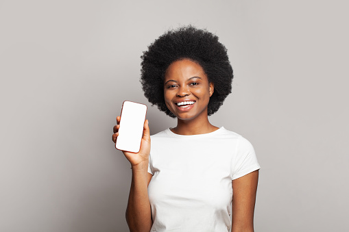 Attractive woman with mobile phone with empty copy space on white