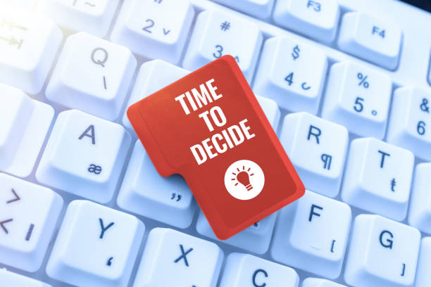 istock Conceptual display Time To Decide. Concept meaning Right moment for make a choice between some alternatives Man In Suit Presenting With Hand Digital Symbols For Business. 1417289440