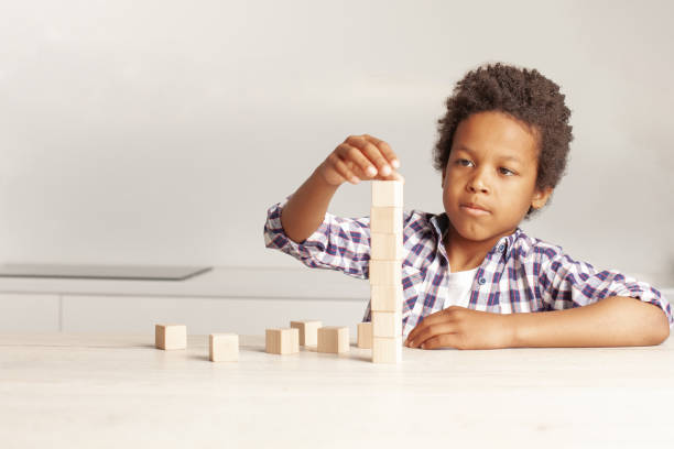 istock Serious kid with empty wooden cubes portrait 1417291410